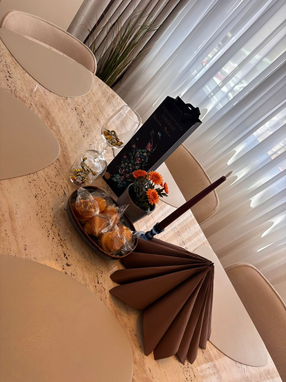 Living room with decorative wallpaper and dining area
